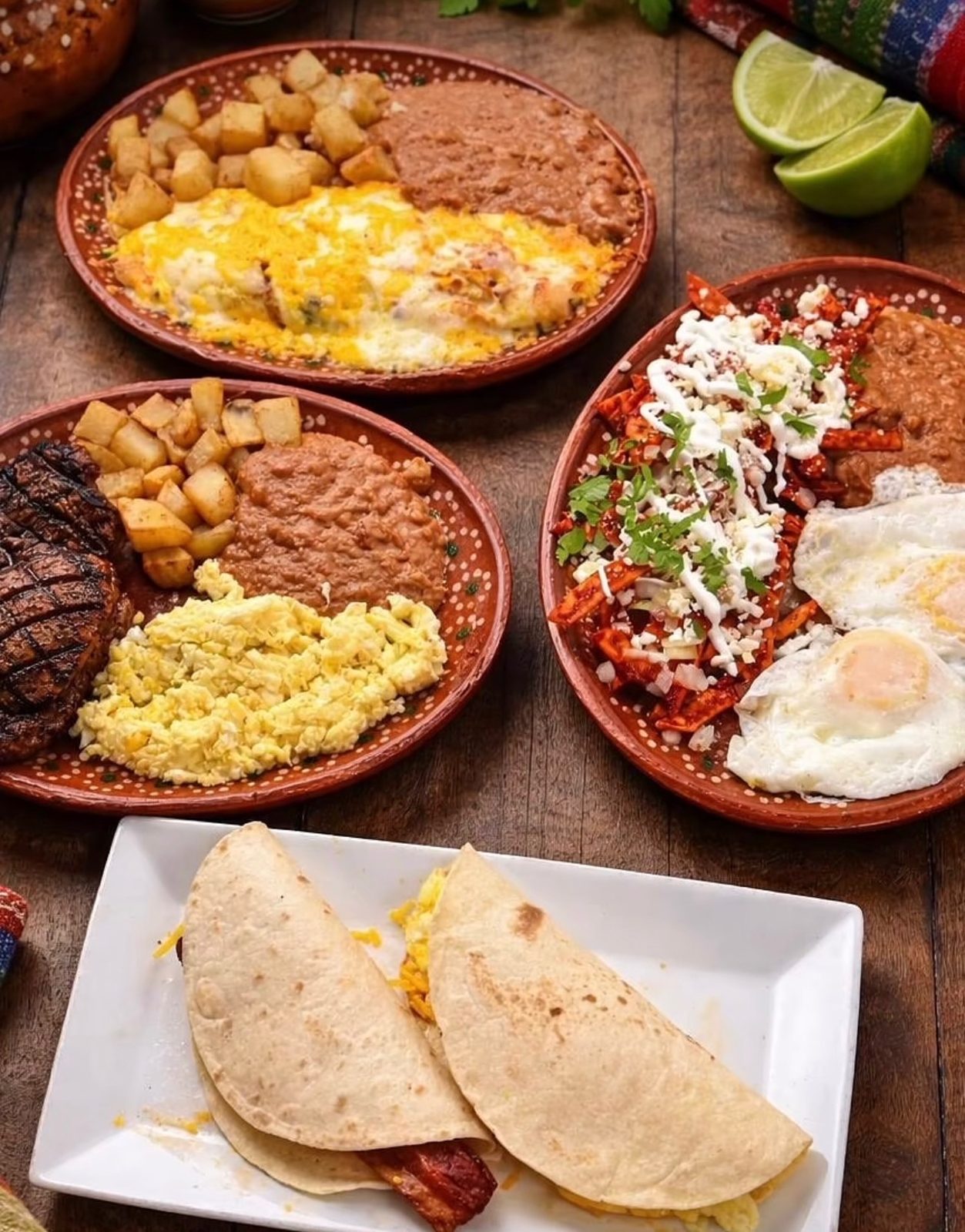Breakfast plates with eggs, chilaquiles, beans and breakfast tacos